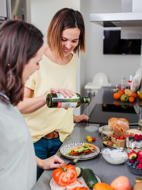 Women preparing healthy food in kitchen having fun, concept dieting nutrition.